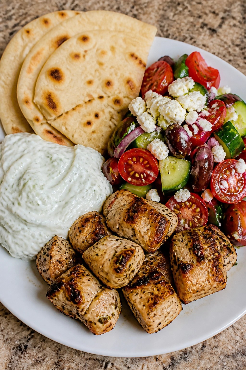 Grilled Chicken Souvlaki Plates with Tzatziki, Pita, and Greek Salad