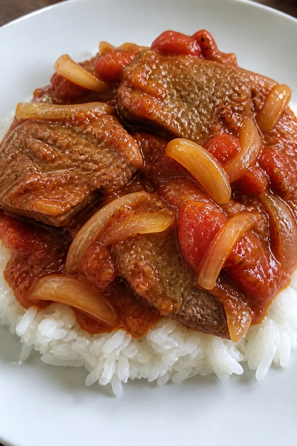 Swiss Steak with Onions and Tomatoes over White Rice
