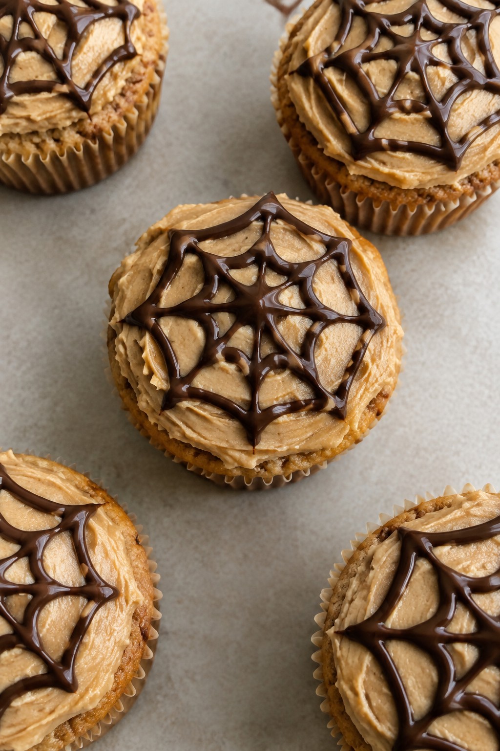 Peanut Butter Cupcakes with Chocolate Spiderweb Topping