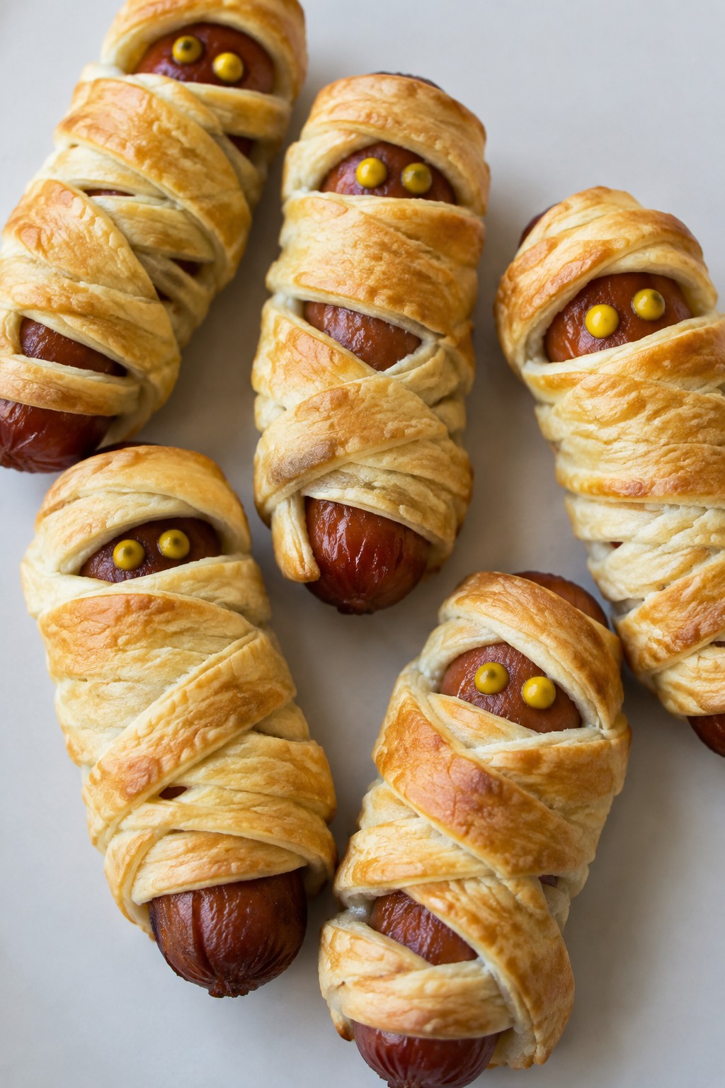 Mummy Hot Dogs with Mustard Eyes