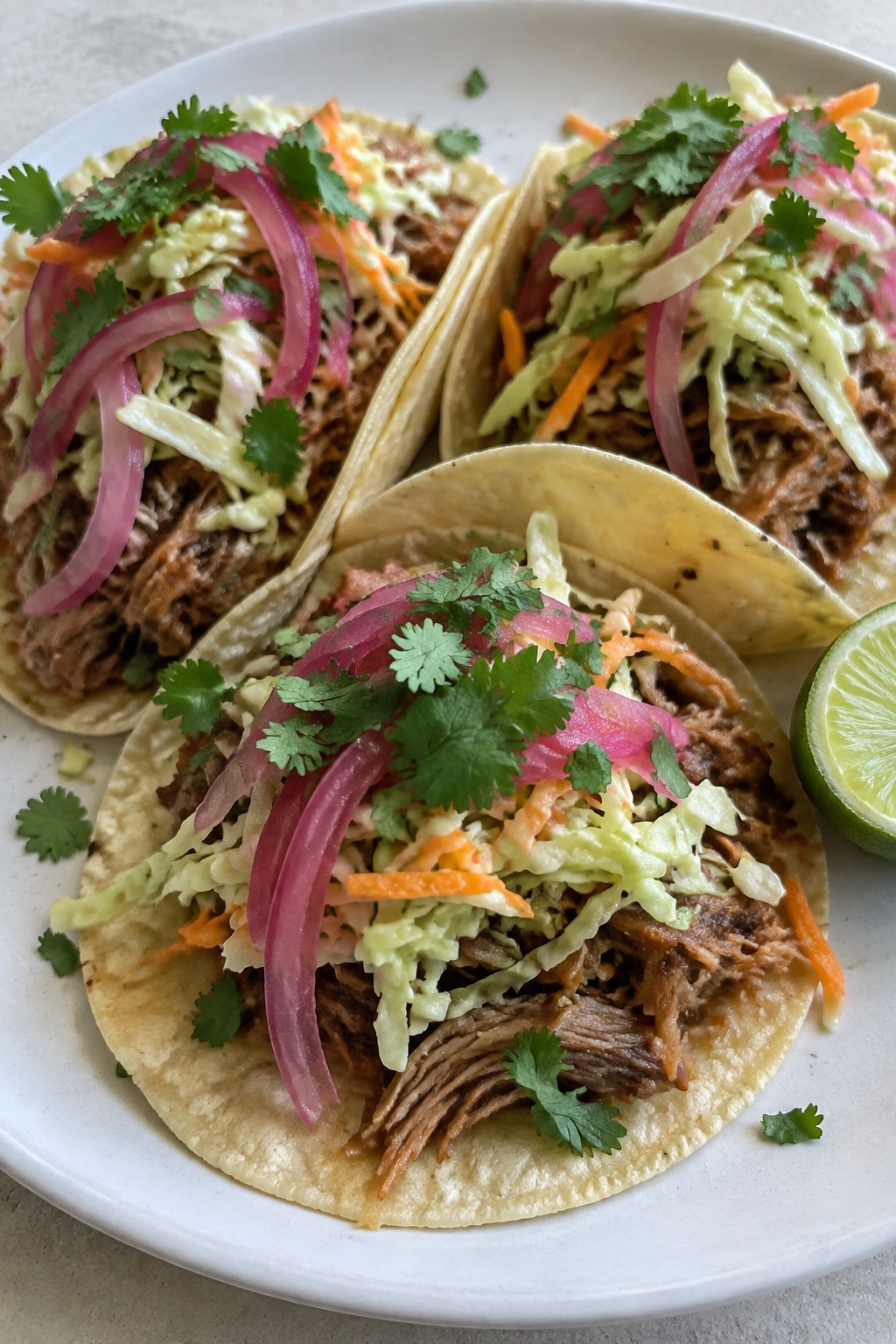 Slow-Cooked Pulled Pork Tacos with Pickled Onions and Slaw