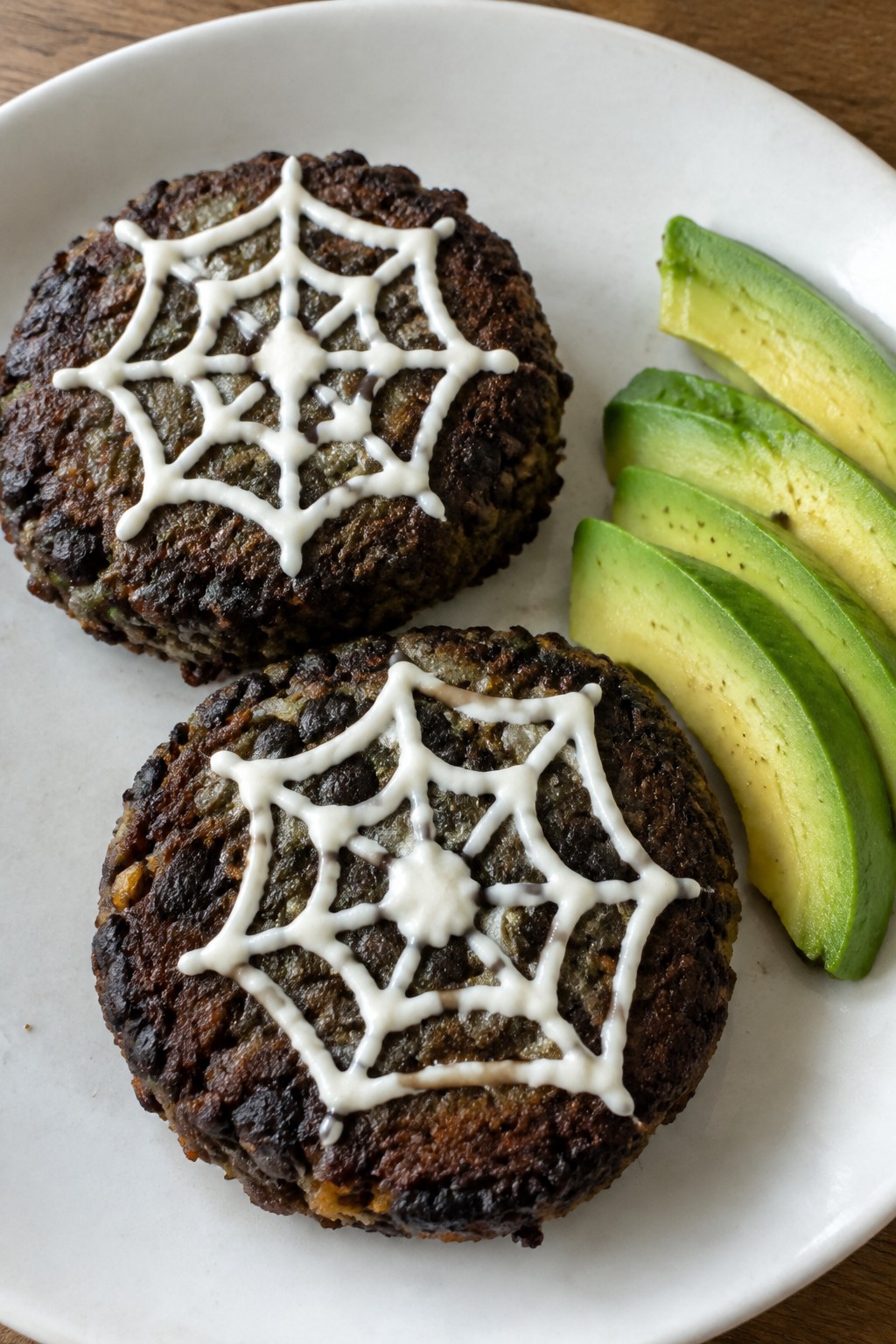 Spiderweb Black Bean Burgers with Avocado Slices